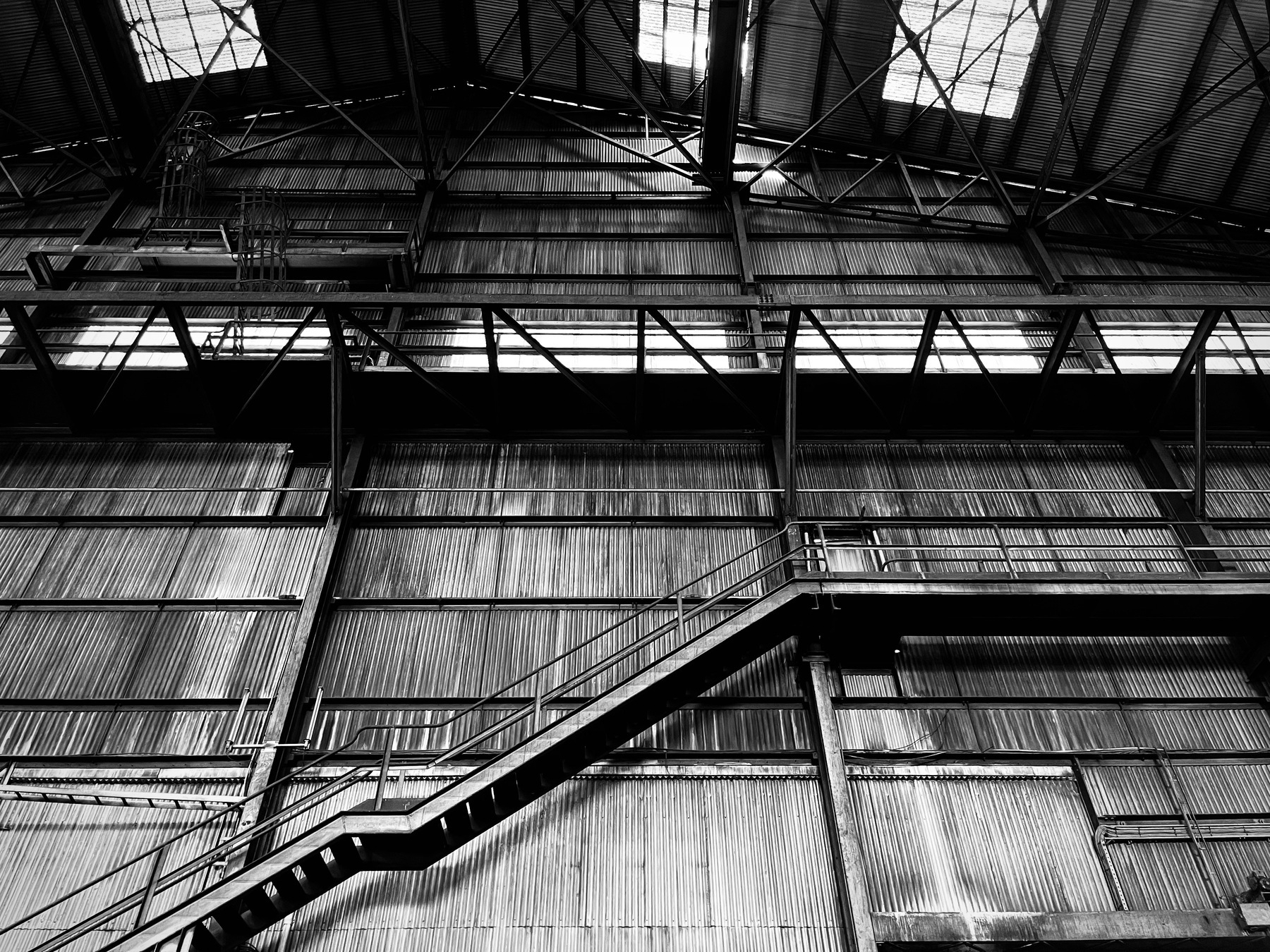 A black-and-white image of a staircase in a warehouse