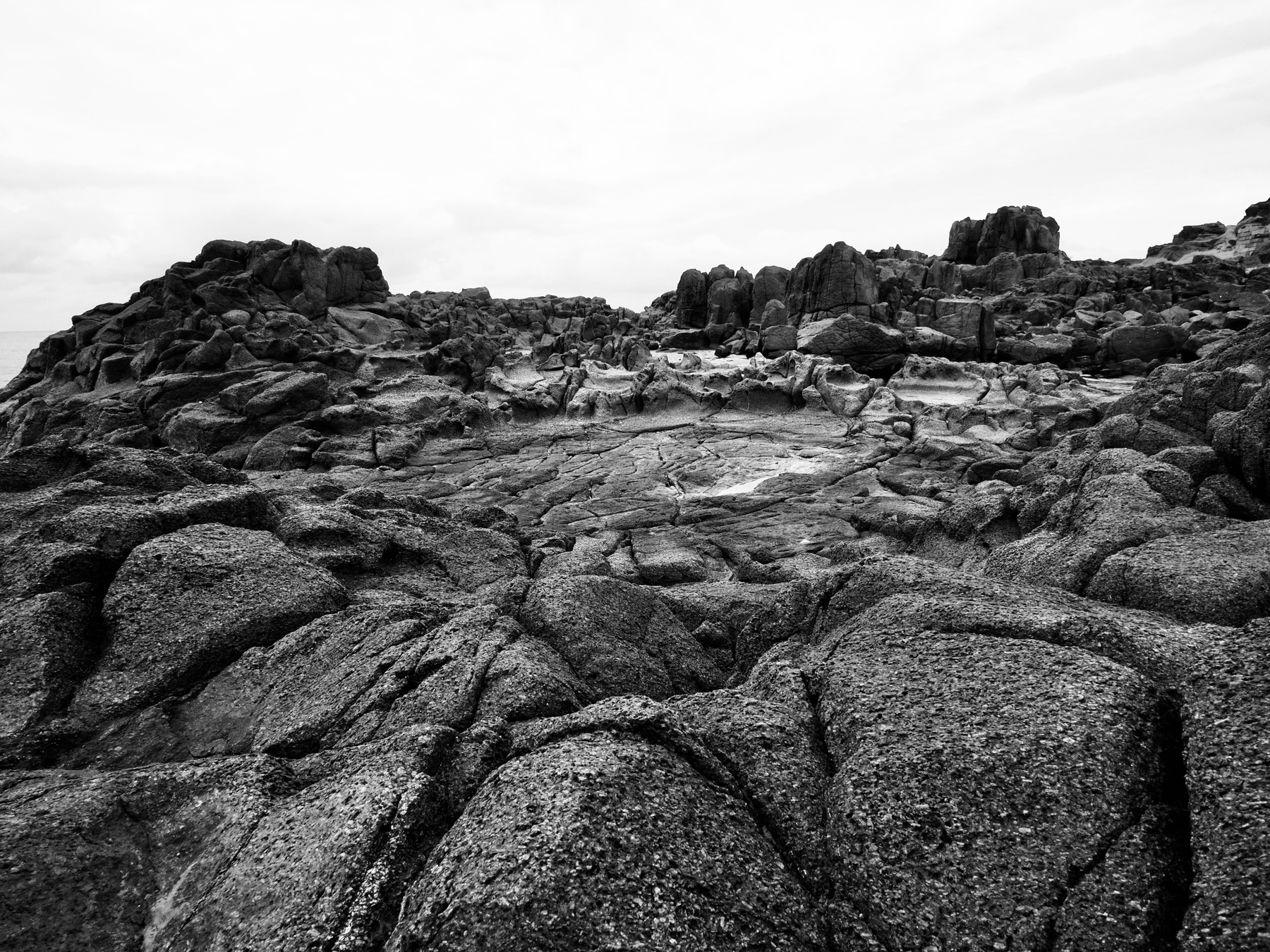 A black-and-white image of a rocky landscape